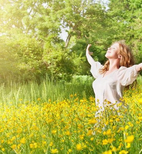 blissful woman with arms stretched out to the side